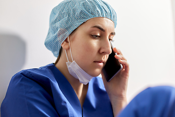 Image showing sad doctor or nurse calling on smartphone