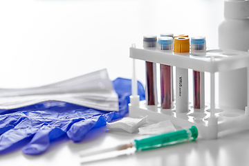 Image showing beakers with virus blood tests, syringe and gloves