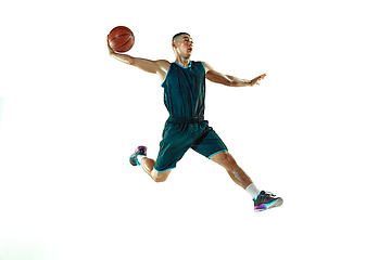 Image showing Young basketball player training isolated on white studio background