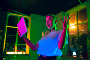 Image showing Cinematic portrait of handsome young woman in neon lighted interior