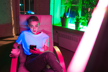 Image showing Cinematic portrait of handsome young woman in neon lighted interior