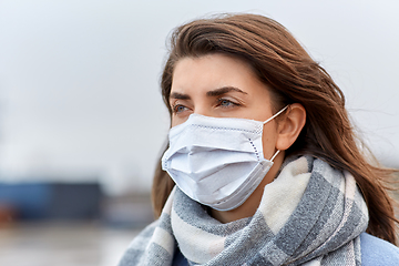 Image showing young woman wearing protective medical mask