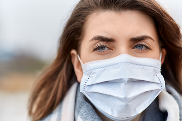 Image showing young woman wearing protective medical mask