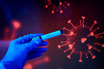 Image showing hand holding beaker with coronavirus blood test