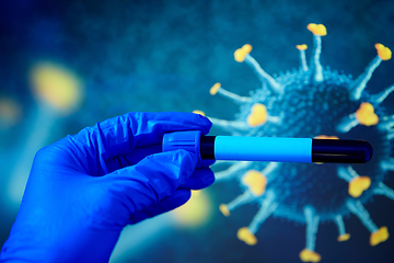 Image showing hand holding beaker with coronavirus blood test