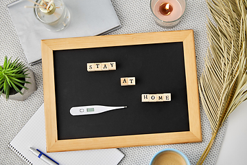 Image showing chalkboard with stay at home words on toy blocks