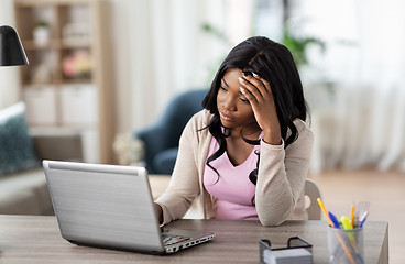 Image showing stressed woman with laptop working at home office