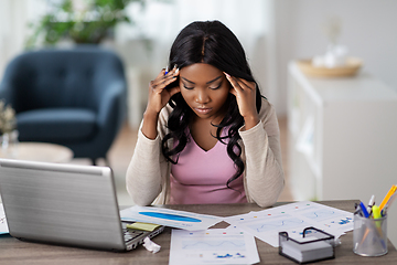 Image showing stressed woman with papers working at home office
