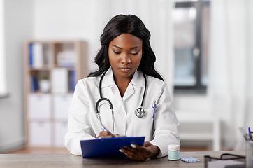 Image showing african american doctor with clipboard at hospital