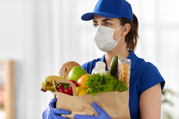 Image showing delivery woman in face mask with food in paper bag