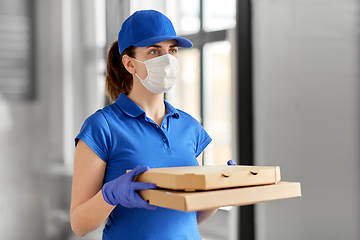 Image showing delivery woman in face mask with pizza boxes