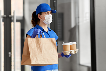 Image showing delivery woman in face mask with food and drinks