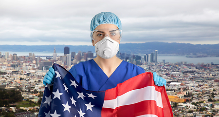 Image showing doctor in goggles and mask holding flag of america