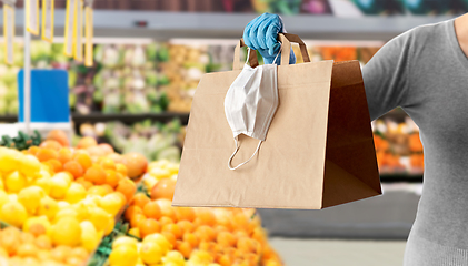 Image showing woman with shopping bag, mask and glove at grocery