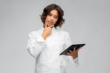 Image showing female chef in toque with tablet computer