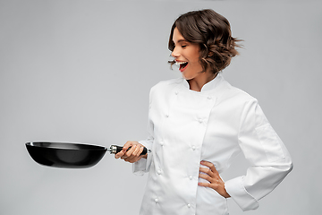 Image showing smiling female chef in toque with frying pan