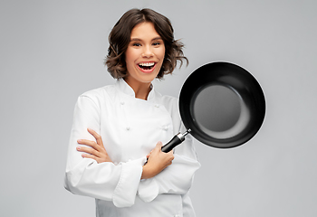 Image showing smiling female chef in toque with frying pan