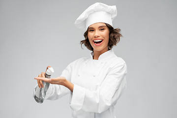 Image showing female chef with hand sanitizer or liquid soap