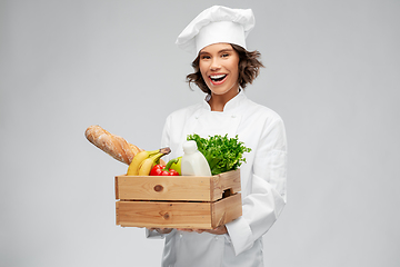 Image showing happy smiling female chef with food in wooden box