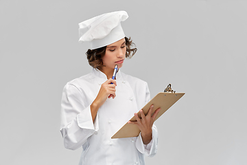 Image showing female chef in toque with clipboard