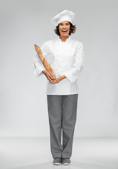 Image showing happy female chef with french bread or baguette