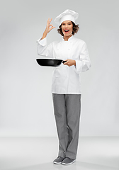 Image showing smiling female chef with frying pan showing ok