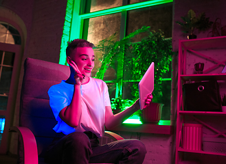 Image showing Cinematic portrait of handsome young woman in neon lighted interior