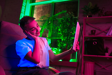 Image showing Cinematic portrait of handsome young woman in neon lighted interior