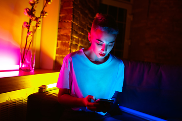 Image showing Cinematic portrait of handsome young woman in neon lighted interior