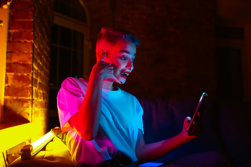 Image showing Cinematic portrait of handsome young woman in neon lighted interior