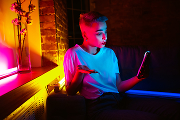 Image showing Cinematic portrait of handsome young woman in neon lighted interior