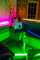 Image showing Cinematic portrait of handsome young woman in neon lighted interior