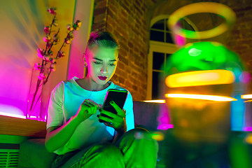 Image showing Cinematic portrait of handsome young woman in neon lighted interior