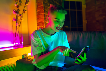 Image showing Cinematic portrait of handsome young woman in neon lighted interior