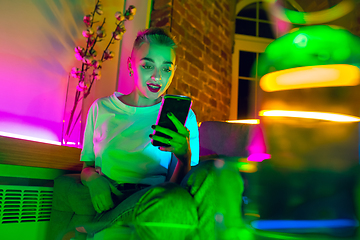 Image showing Cinematic portrait of handsome young woman in neon lighted interior