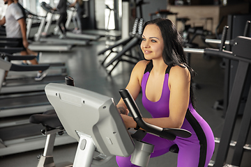 Image showing The female athlete training hard in the gym. Fitness and healthy life concept.