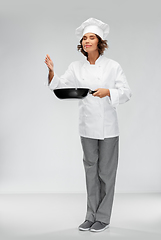 Image showing female chef with frying pan smelling food flavor