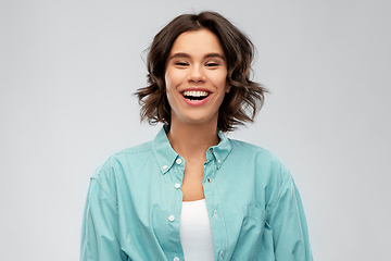 Image showing portrait of smiling young woman in turquoise shirt