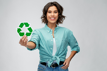 Image showing smiling young woman holding green recycling sign