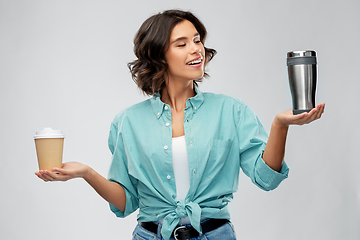 Image showing woman comparing thermo cup and paper coffee cup