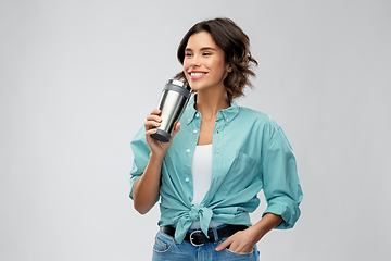 Image showing woman with thermo cup or tumbler for hot drinks