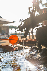 Image showing Bamboo fountain and dragon under sunlight