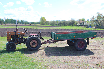 Image showing tractor with trailer in the village