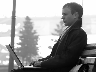 Image showing Young businesman with laptop