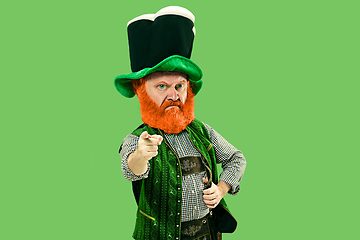 Image showing Excited leprechaun in green suit with red beard on white background