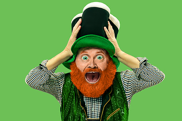 Image showing Excited leprechaun in green suit with red beard on white background