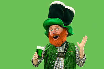 Image showing Excited leprechaun in green suit with red beard on white background