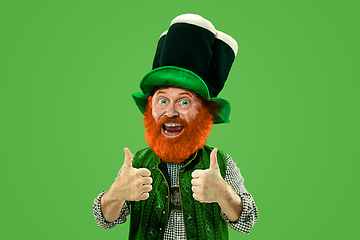 Image showing Excited leprechaun in green suit with red beard on white background