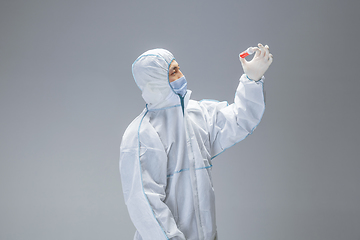 Image showing Medic in white hazmat protective suit, coronavirus illustration concept