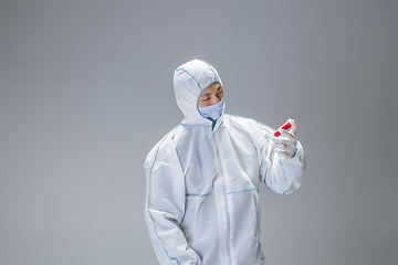 Image showing Medic in white hazmat protective suit, coronavirus illustration concept